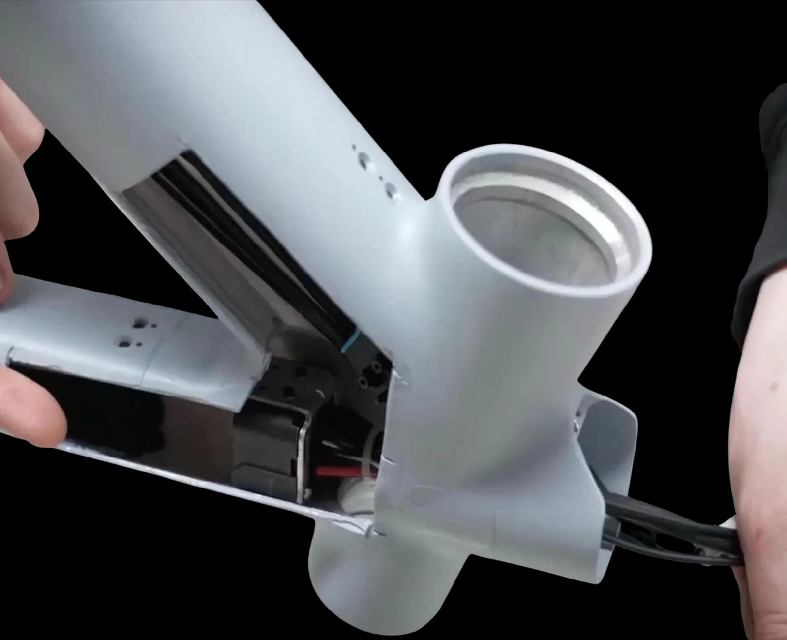 An opened VanMoof frame, with the wiring loom running through the tube.